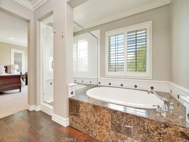 bathroom featuring hardwood / wood-style flooring, plenty of natural light, ornamental molding, and shower with separate bathtub