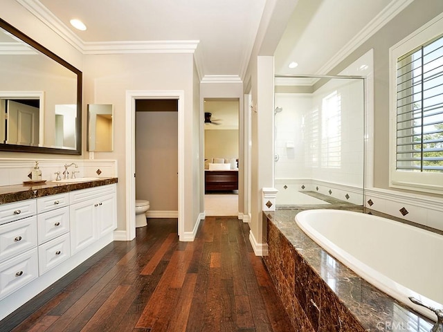 full bathroom with toilet, separate shower and tub, ornamental molding, vanity, and hardwood / wood-style flooring