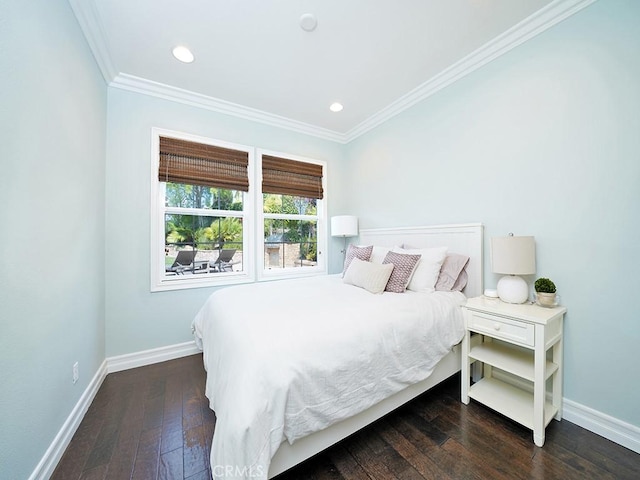 bedroom with crown molding and dark hardwood / wood-style floors