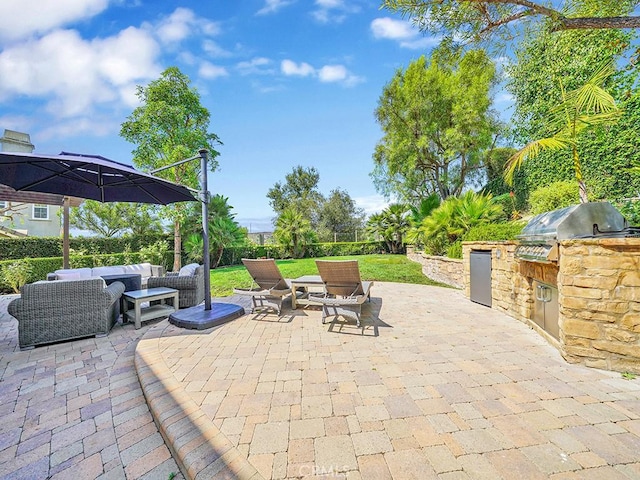 view of patio with an outdoor kitchen, a grill, and an outdoor hangout area