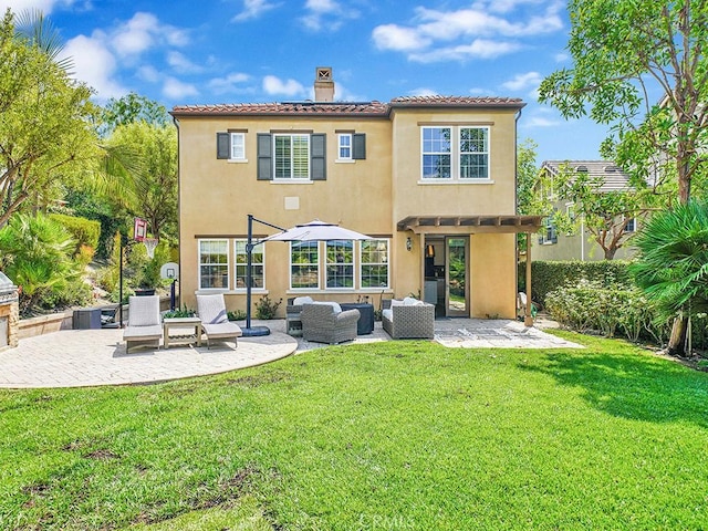 back of house featuring a yard, outdoor lounge area, and a patio area