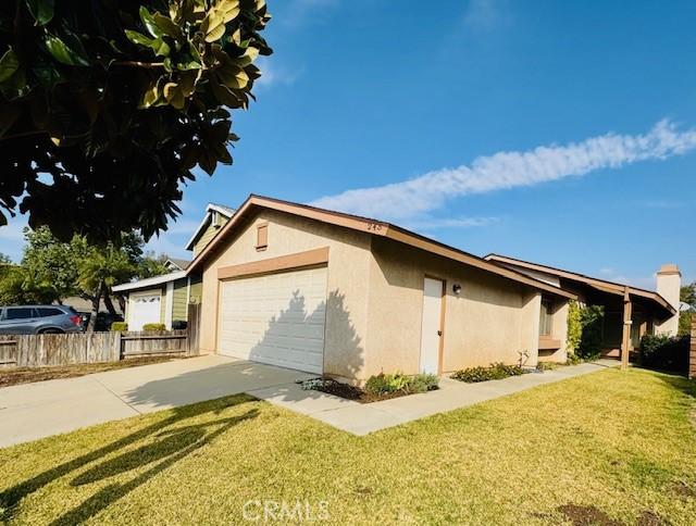 view of side of property with a garage and a lawn