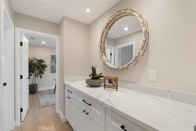 bathroom featuring vanity and wood-type flooring