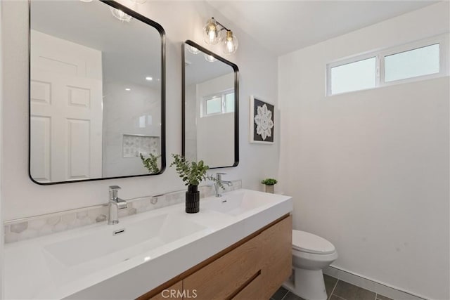 bathroom with tile patterned floors, vanity, and toilet