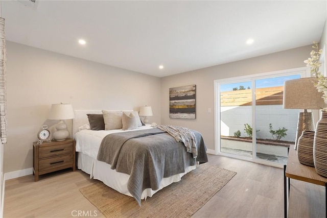 bedroom featuring access to exterior and light wood-type flooring