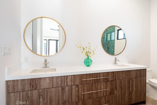 bathroom featuring vanity and toilet