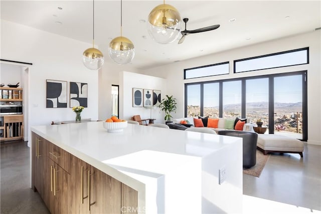 kitchen with decorative light fixtures, a mountain view, and a high ceiling