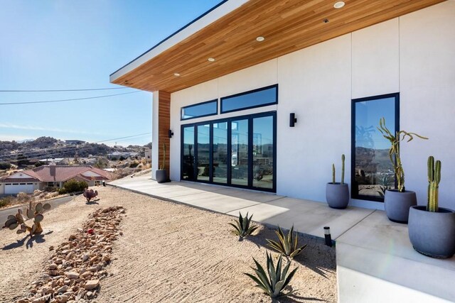 entrance to property featuring a patio area