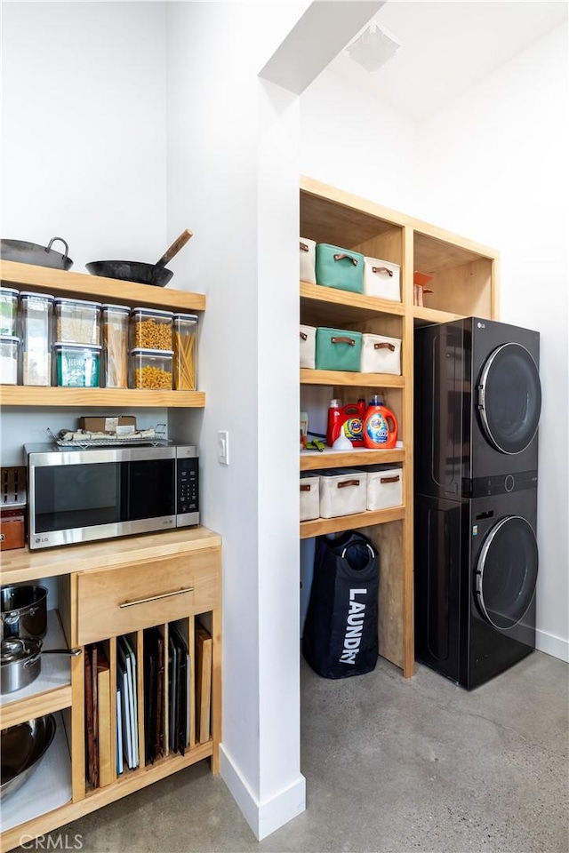 interior space featuring stacked washing maching and dryer