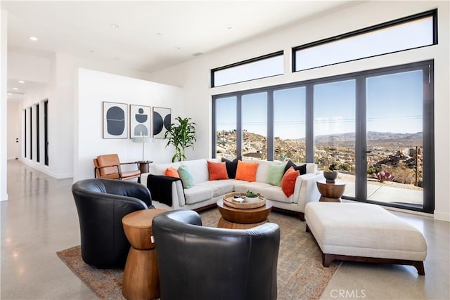 living room with concrete flooring and a mountain view