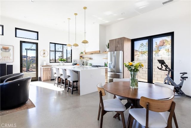 dining area with a towering ceiling