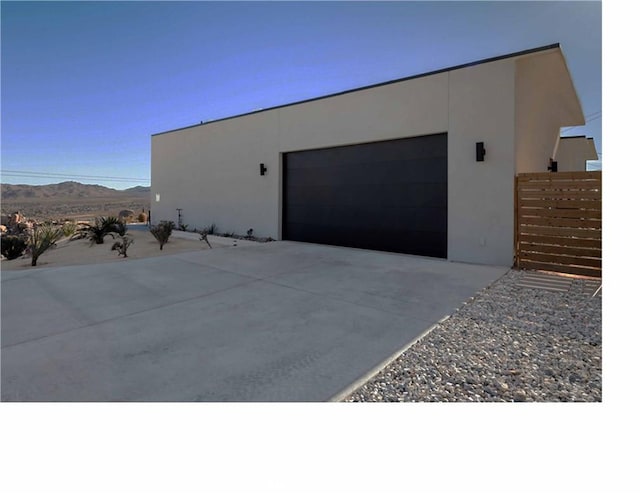 view of property exterior featuring a mountain view and a garage