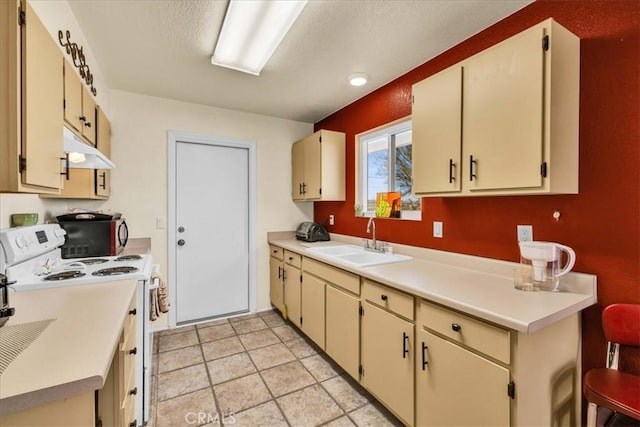 kitchen with light tile patterned flooring, sink, a textured ceiling, cream cabinets, and white range with electric stovetop