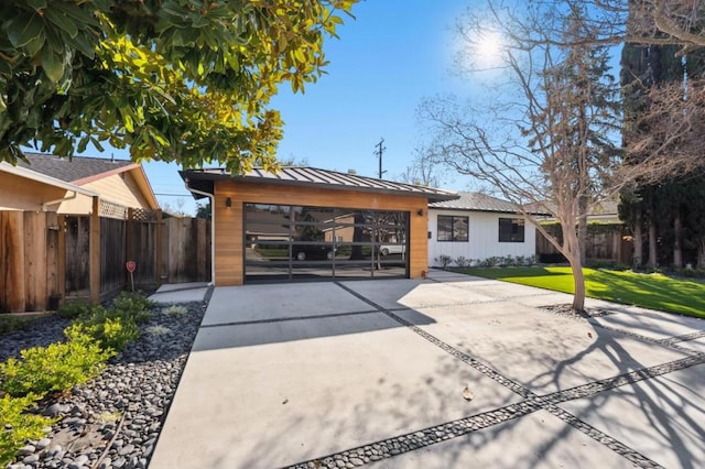 back of property with a garage and a lawn