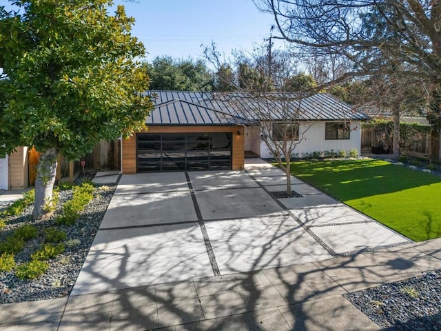 view of front of property featuring a garage and a front lawn