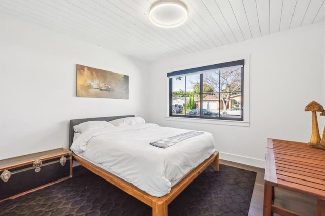 bedroom with hardwood / wood-style flooring and wooden ceiling