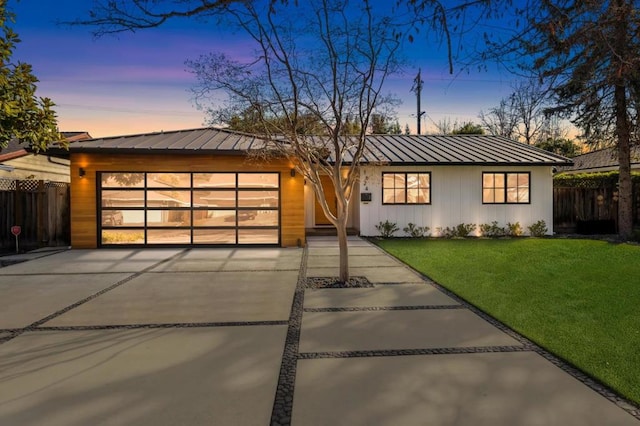 view of front of house with a yard and a garage