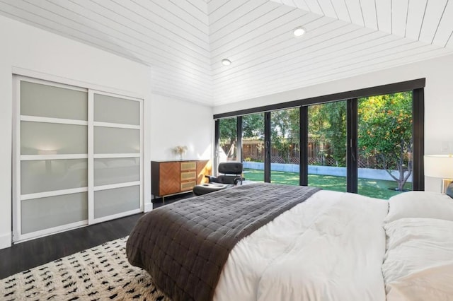 bedroom with dark hardwood / wood-style flooring and access to exterior