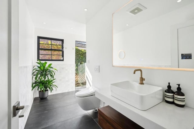 bathroom featuring vanity and toilet