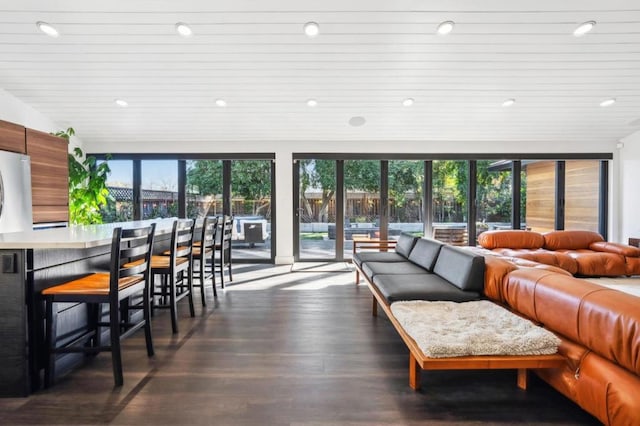 living room featuring plenty of natural light, wood ceiling, and dark hardwood / wood-style flooring