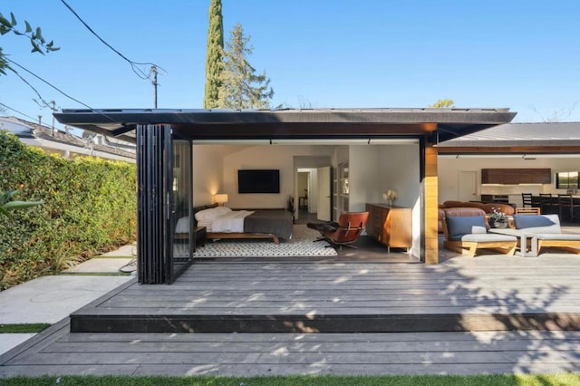 rear view of property featuring an outdoor hangout area and a deck