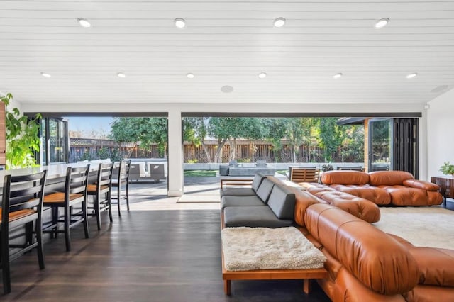 living room featuring a healthy amount of sunlight and dark hardwood / wood-style floors