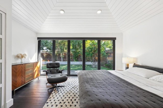 bedroom featuring vaulted ceiling, dark hardwood / wood-style floors, and access to outside