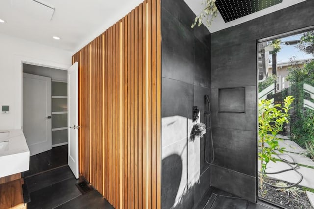 bathroom with vanity and tiled shower