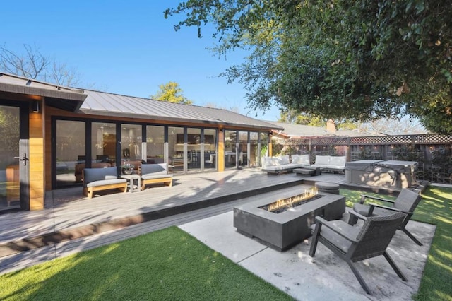 view of patio featuring an outdoor living space with a fire pit, a hot tub, and a deck