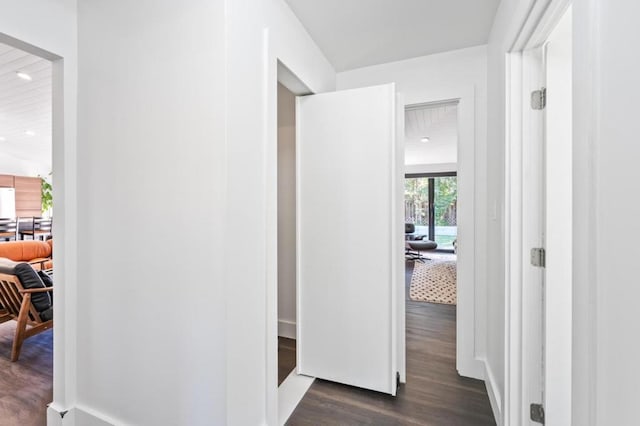 corridor with dark hardwood / wood-style floors