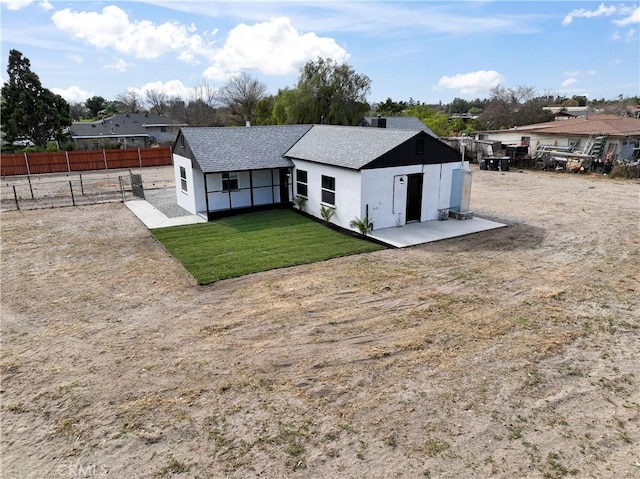 back of property featuring a lawn