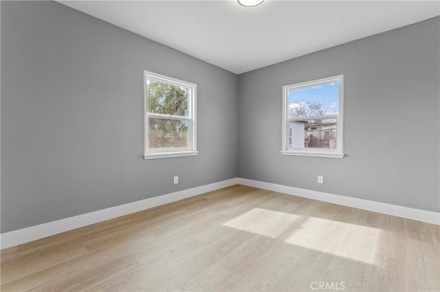 spare room featuring light wood-type flooring