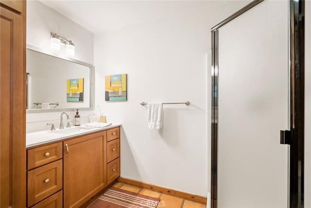 bathroom with tile patterned flooring, vanity, and an enclosed shower