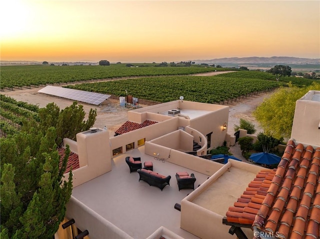 aerial view at dusk featuring a rural view