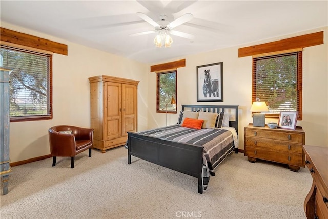 bedroom featuring ceiling fan and light carpet