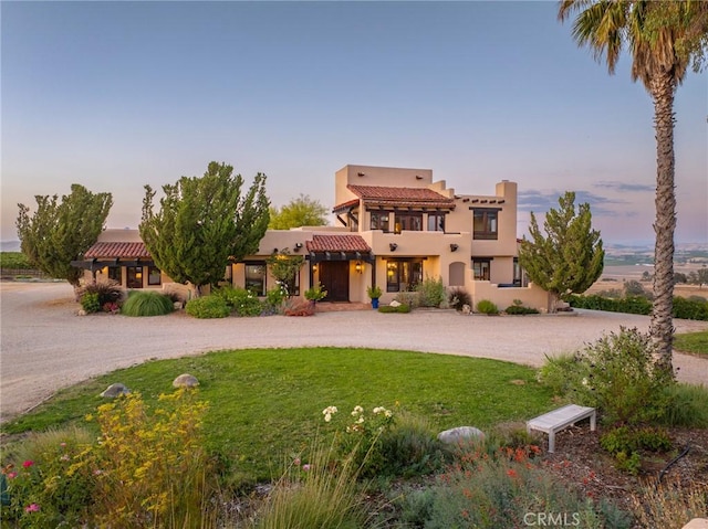 pueblo-style house with a lawn