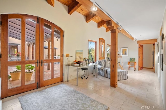 doorway with french doors, beam ceiling, and wooden ceiling