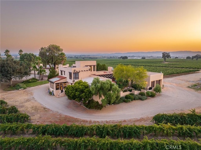 aerial view at dusk featuring a rural view