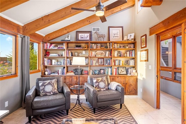 sitting room featuring lofted ceiling with beams, light tile patterned flooring, and ceiling fan