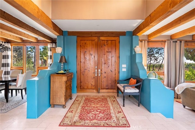 entrance foyer with beamed ceiling and a wealth of natural light