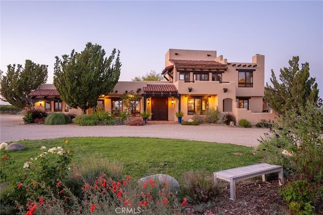 pueblo-style home with a yard