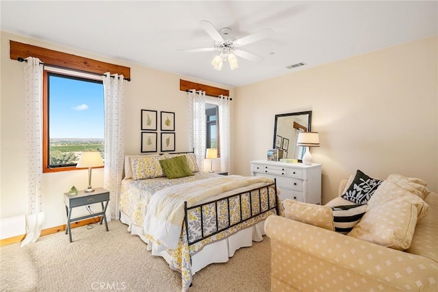 bedroom with light carpet and ceiling fan