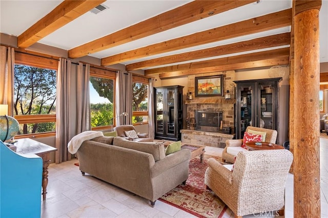 living room featuring beam ceiling and a fireplace