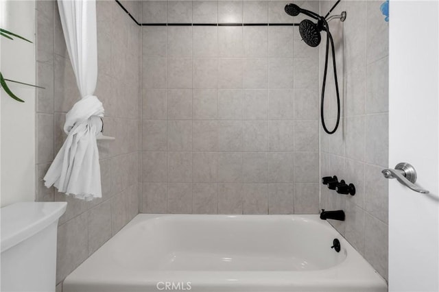 bathroom with shower / bath combination with curtain and toilet