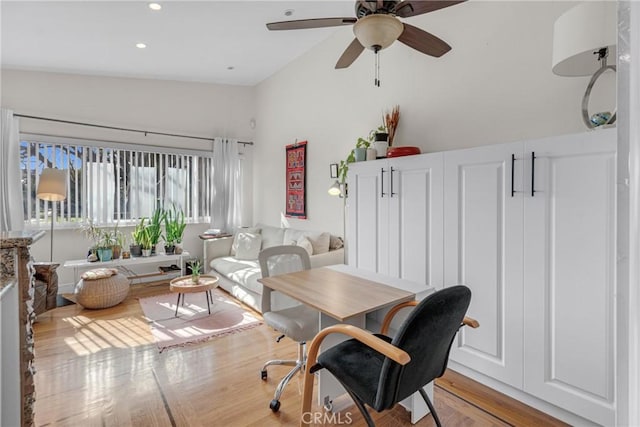 office with ceiling fan, lofted ceiling, and light hardwood / wood-style floors