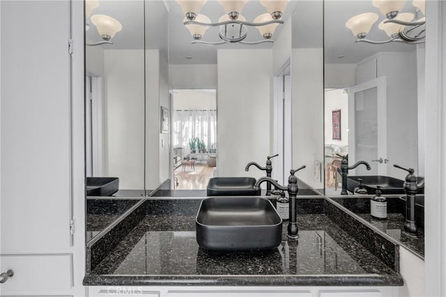 bathroom with sink and an inviting chandelier