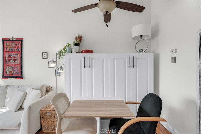 dining space with hardwood / wood-style floors and ceiling fan