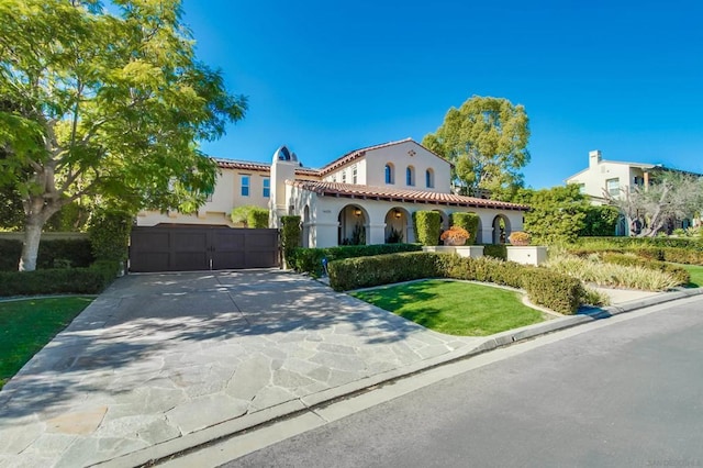 mediterranean / spanish house with a garage