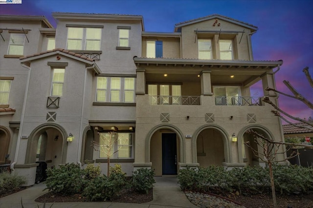 view of front of home with a balcony