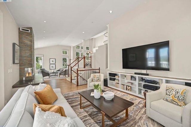 living room featuring hardwood / wood-style flooring and vaulted ceiling